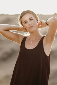 Portrait of woman standing at beach