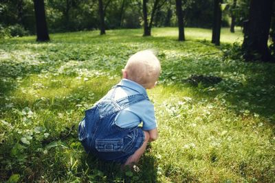 Rear view of boy standing on grass