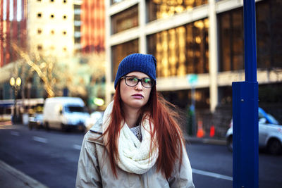 Portrait of beautiful young woman in car on street