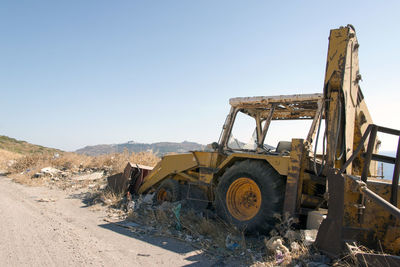 Wrecked and abandoned cars and ships in a remore location in the island