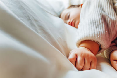 High angle view of baby sleeping on bed