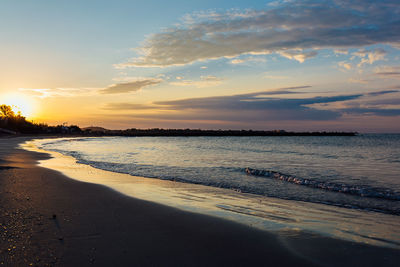 Scenic view of beach against sky during sunset