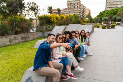 Portrait of young couple sitting outdoors