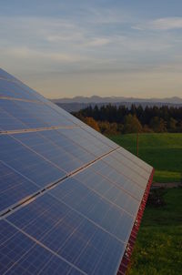 Solar panel on field against sky