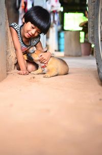 Low section of woman with dog on floor