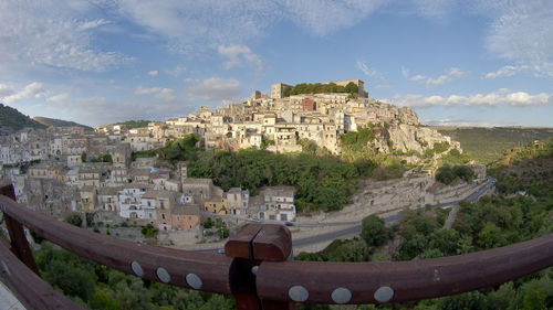 Old town by buildings in city against sky