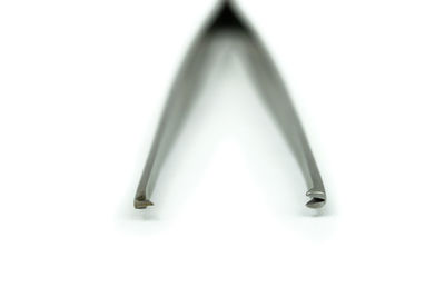 Close-up of metallic object over white background