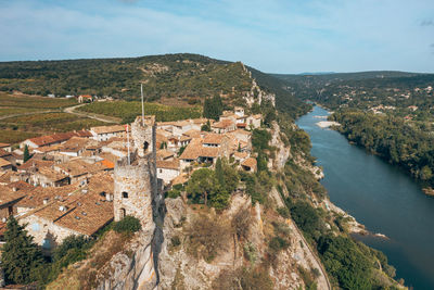 High angle view of townscape by mountain against sky