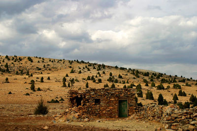 Scenic view of historic building against cloudy sky