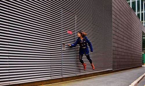 Full length of woman standing by railing