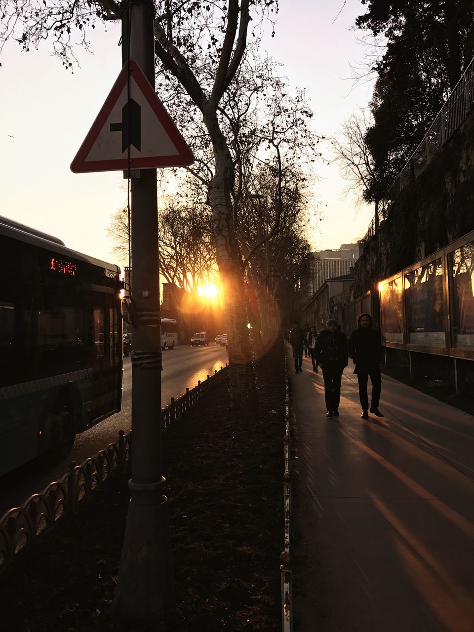 sunset, street, real people, street light, sky, outdoors, silhouette, tree, men, nature, illuminated, architecture, beauty in nature, day, adult, people, adults only