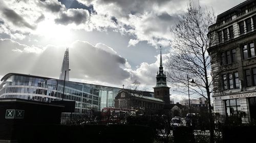 Low angle view of buildings against cloudy sky