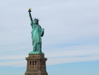 Low angle view of statue of liberty against sky