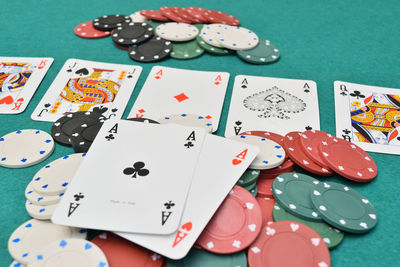 Gambling chips with cards on table