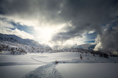 Scenic view of snow covered mountains against sky