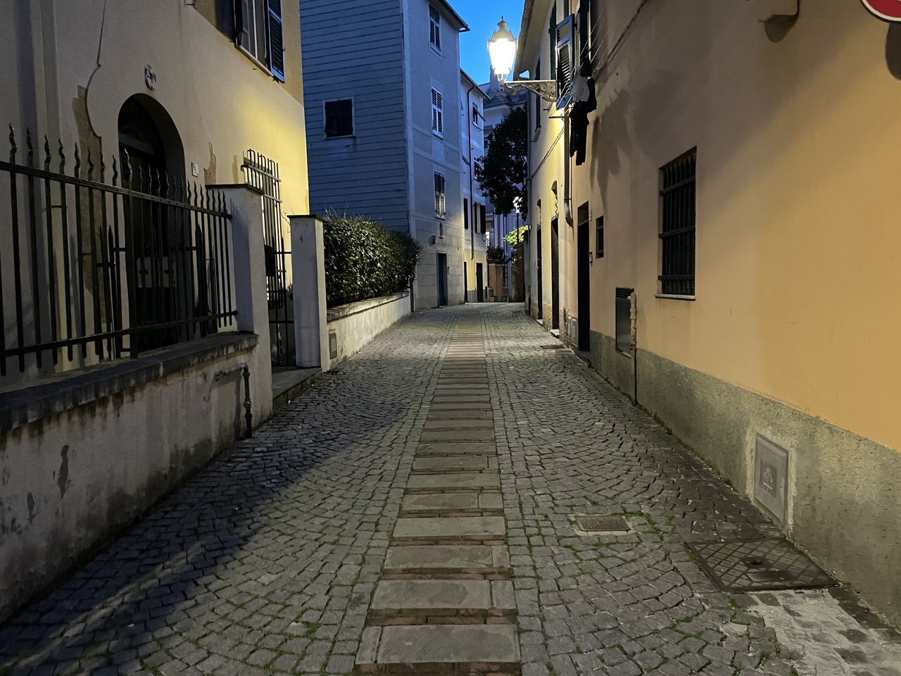 alley, architecture, road, street, building exterior, built structure, city, building, the way forward, urban area, infrastructure, lane, cobblestone, residential district, footpath, town, diminishing perspective, no people, narrow, neighbourhood, outdoors, nature, house, wall, road surface, sky, lighting equipment, travel destinations, transportation