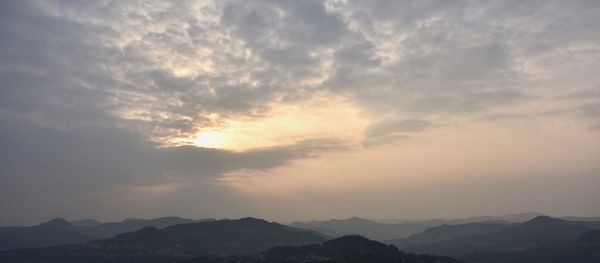 Scenic view of silhouette mountains against sky during sunset