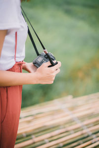 Midsection of woman holding umbrella