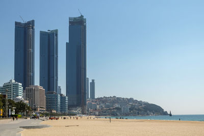 Panoramic view of sea and buildings against clear sky