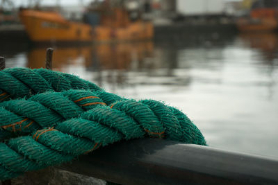 Close-up of rope on boat over lake