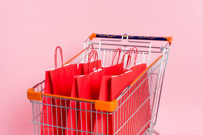 Close-up of miniature shopping cart against white background