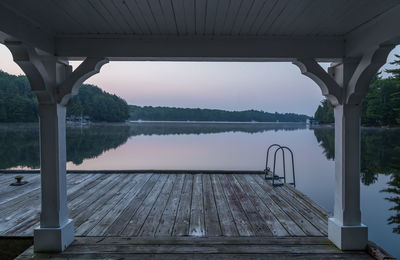 View of swimming pool by lake against sky