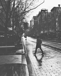 Man walking on road in city