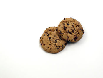 High angle view of cookies in plate against white background