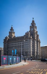 Buildings in city against blue sky