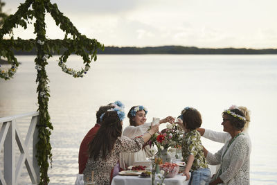 Family having midsummer meal at lake