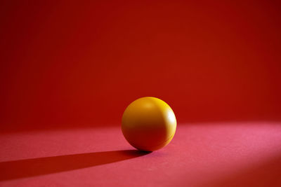 Close-up of yellow ball on table