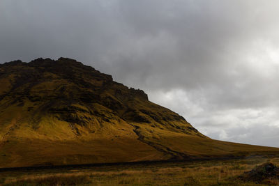 Scenic view of mountains against cloudy sky