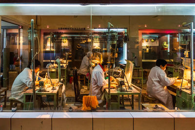 People working in restaurant at night
