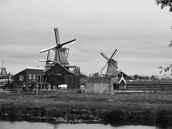 Traditional windmill on field against sky