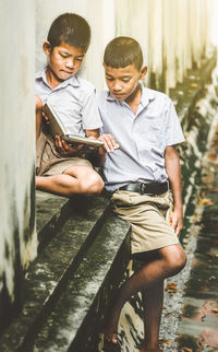 Happy friends sitting on mobile phone