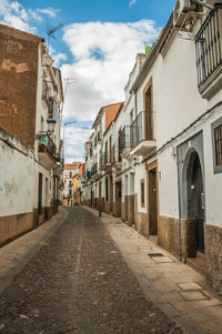 Empty road amidst buildings in town