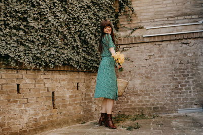 Woman standing against wall