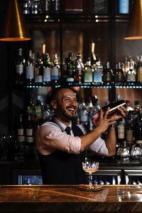 Portrait of a man with drink in bar