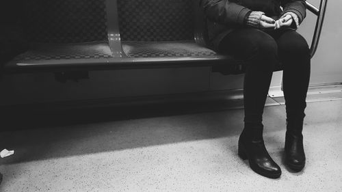 Low section of woman sitting on seat