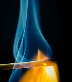 Close-up of illuminated lighting equipment against black background