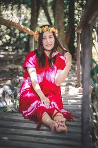 Portrait of smiling young woman sitting outdoors