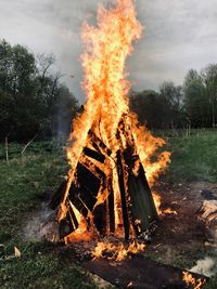 Panoramic shot of fire on field against sky
