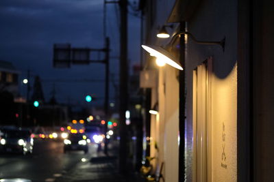 Illuminated street light in city at night