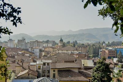 Buildings in city against clear sky