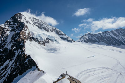 Scenic view of snow covered mountains against sky