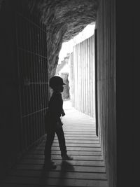 Side view of man standing in corridor