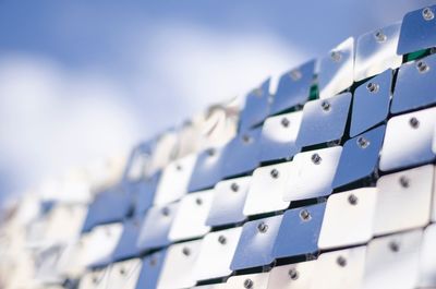 Low angle view of communications tower against blue sky