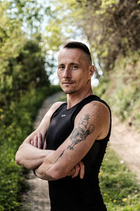 Portrait of man standing against plants