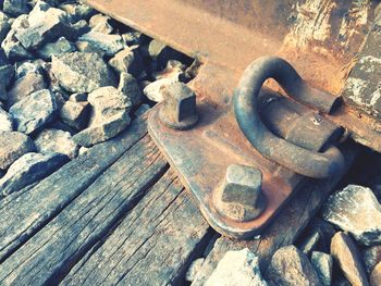 High angle view of rusty metal on wood