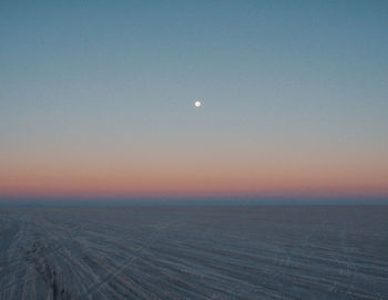 Scenic view of sea against clear sky during sunset